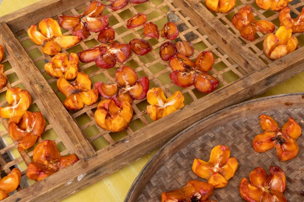 The Art of Drawing Readers In: Your attractive post title goes here Close-up of sun-dried fruits placed on wooden trays, showcasing natural preservation techniques.